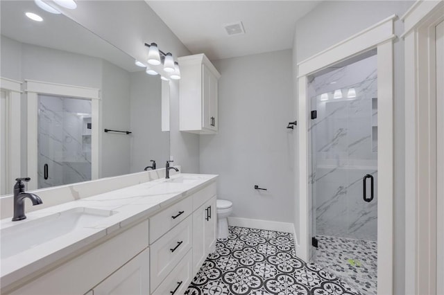 1410 Rochester St, Bryan, TX 77803 - bathroom featuring a marble finish shower, double vanity, and tile patterned floors