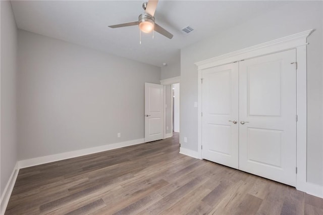 1410 Rochester St, Bryan, TX 77803 - unfurnished bedroom featuring wood finished floors, a closet, and ceiling fan