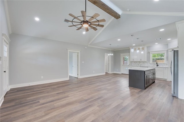 1410 Rochester St, Bryan, TX 77803 - kitchen featuring freestanding refrigerator, open floor plan, light countertops, a ceiling fan, and beam ceiling