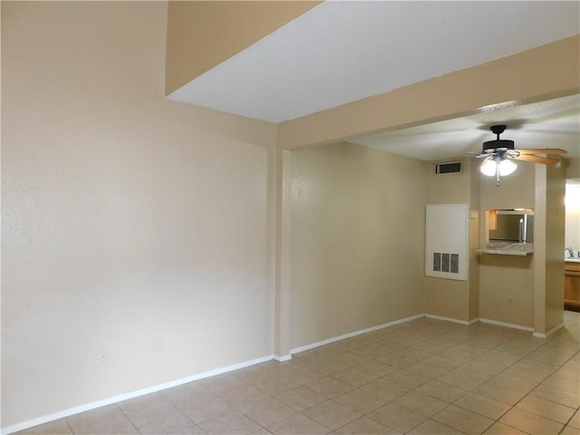 unfurnished room featuring ceiling fan and light tile patterned floors