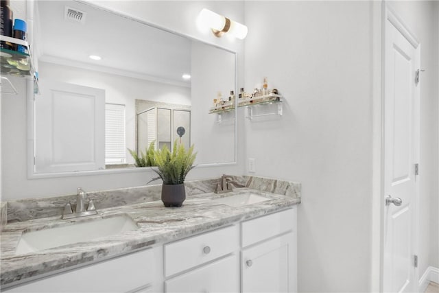 bathroom featuring vanity and a shower with door