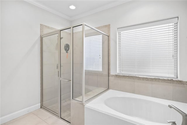 bathroom with tile patterned flooring, independent shower and bath, a wealth of natural light, and ornamental molding