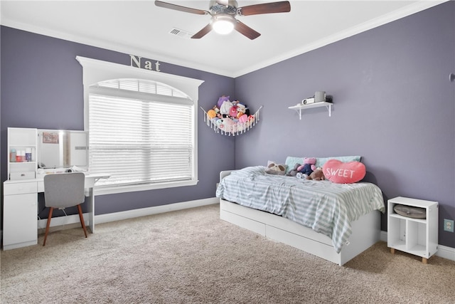 carpeted bedroom with ceiling fan and ornamental molding