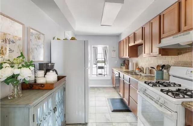 318 Kyle Ave, College Station, TX 77840 - kitchen with white appliances, under cabinet range hood, a sink, and light countertops