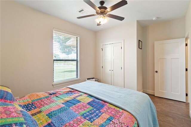 bedroom with hardwood / wood-style floors, ceiling fan, and a closet