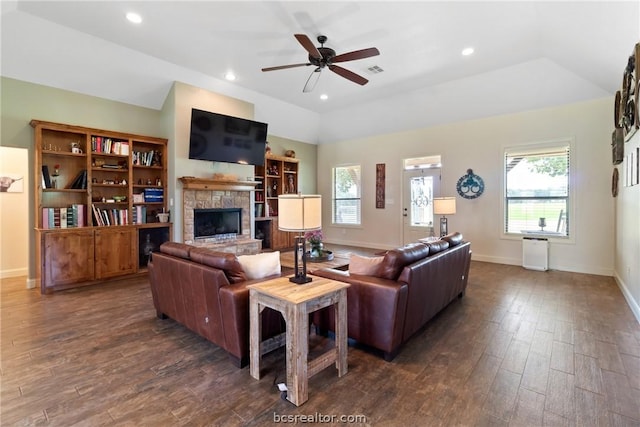 living room with a stone fireplace, ceiling fan, dark wood-type flooring, and lofted ceiling