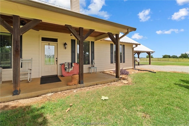 property entrance with a lawn