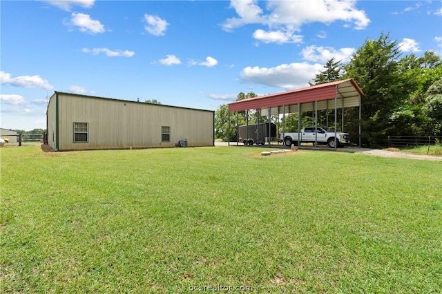 view of yard with an outdoor structure and a carport