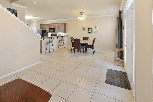 tiled dining area featuring ornamental molding