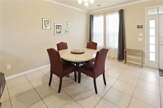 dining room with light tile patterned flooring and ornamental molding