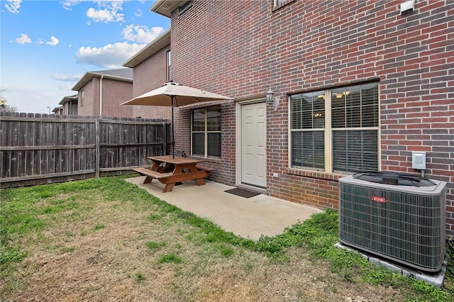 exterior space featuring a patio, central air condition unit, and a lawn