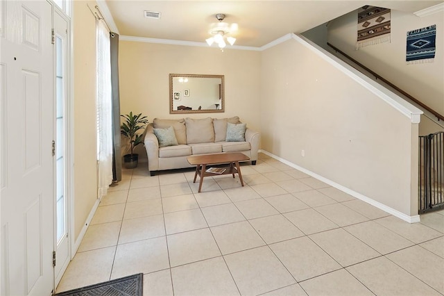 tiled living room featuring crown molding and a wealth of natural light