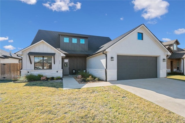 view of front of property featuring a front yard and a garage