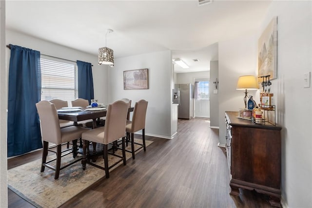 dining room featuring baseboards and dark wood-style flooring