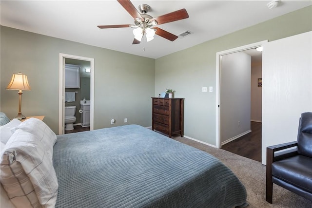 bedroom featuring visible vents, ensuite bathroom, carpet floors, baseboards, and ceiling fan