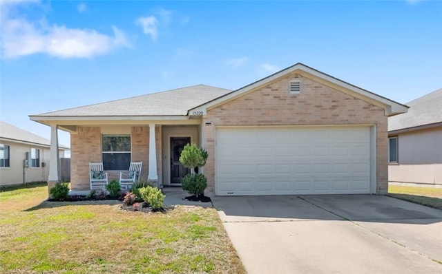 single story home featuring a garage, brick siding, covered porch, and driveway