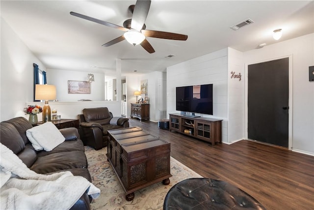 living room featuring ceiling fan, visible vents, and wood finished floors