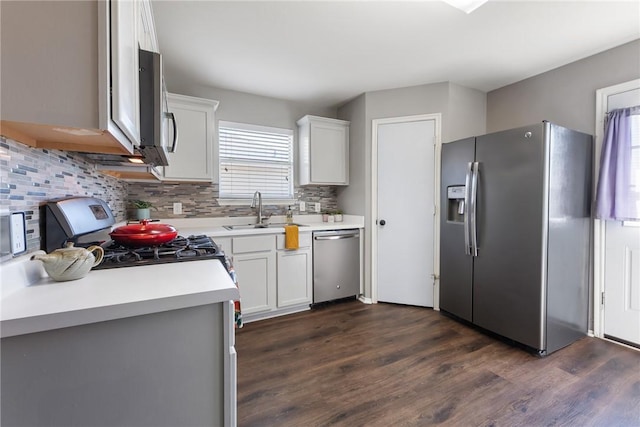 kitchen featuring a sink, stainless steel appliances, tasteful backsplash, and a healthy amount of sunlight