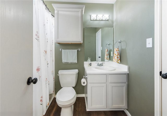 full bathroom with toilet, curtained shower, wood finished floors, baseboards, and vanity