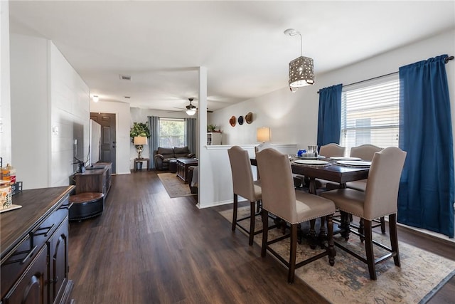 dining space featuring visible vents, dark wood-type flooring, and a ceiling fan