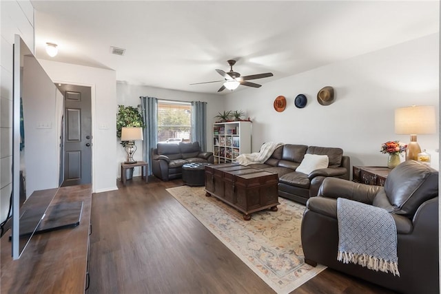 living area featuring a ceiling fan, wood finished floors, and visible vents