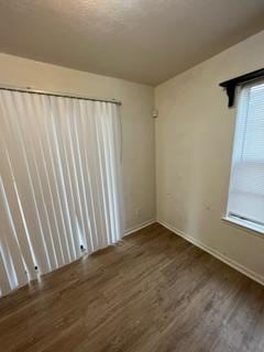 empty room with dark wood-type flooring