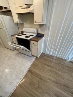 kitchen featuring white cabinetry, dark hardwood / wood-style flooring, and white appliances