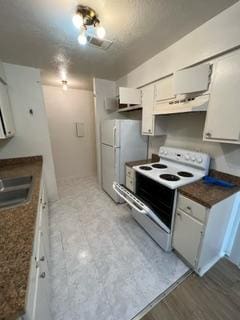 kitchen with white cabinets, white appliances, sink, and exhaust hood