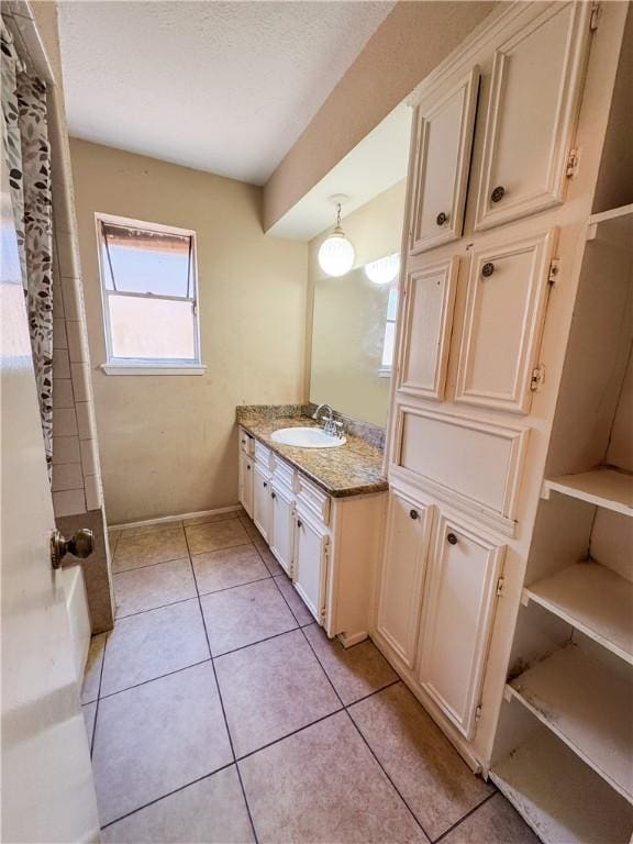 bathroom featuring tile patterned floors, a textured ceiling, and vanity