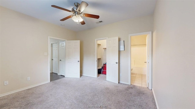 609 Townplace Dr, College Station, TX 77840 - unfurnished bedroom featuring carpet, a walk in closet, ensuite bath, a ceiling fan, and a closet