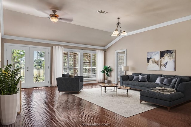 living room featuring french doors, ornamental molding, ceiling fan with notable chandelier, vaulted ceiling, and hardwood / wood-style flooring