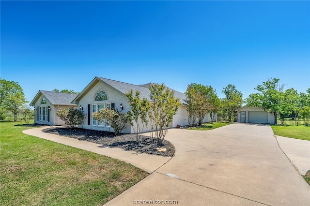 ranch-style home with a front lawn and an outdoor structure