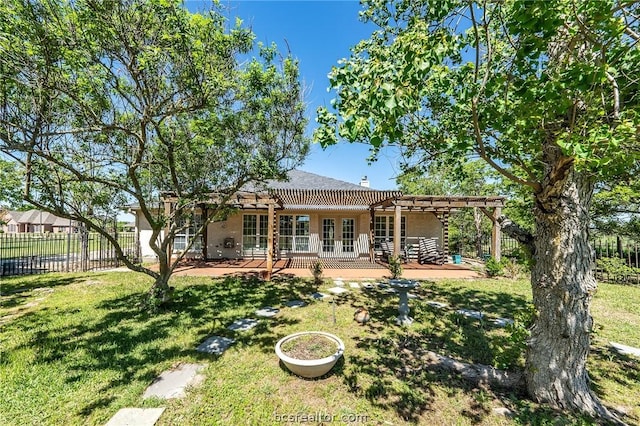 rear view of house featuring a pergola, a patio, and a lawn