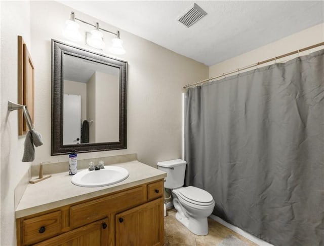 bathroom featuring vanity, curtained shower, and toilet