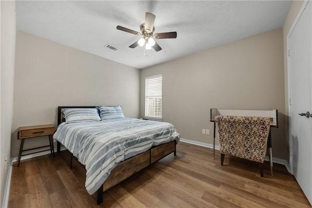 bedroom with ceiling fan and wood-type flooring