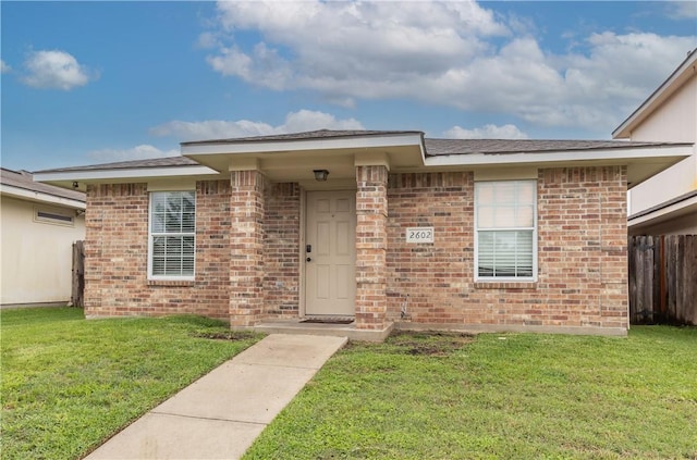 property entrance with a lawn