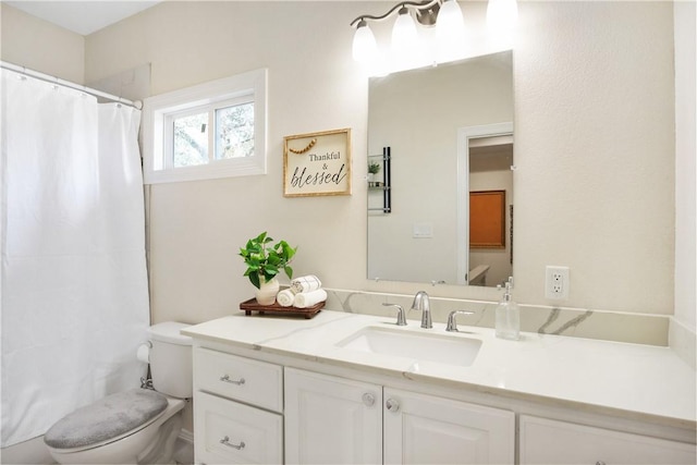 bathroom with vanity, a shower with curtain, and toilet