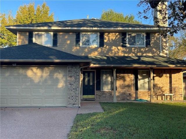 view of front of home with a front yard and a garage