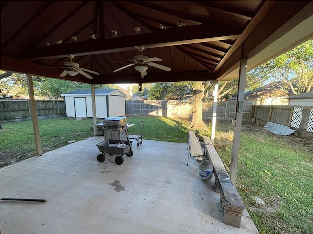 view of patio / terrace with ceiling fan and a shed