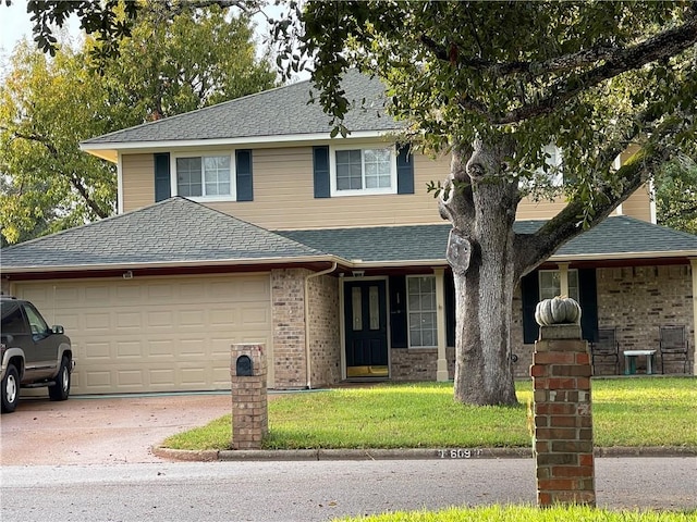 view of front property with a front yard and a garage