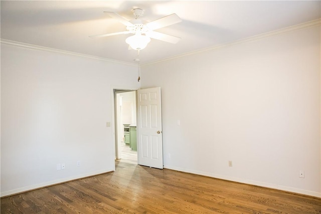 spare room featuring hardwood / wood-style flooring, ornamental molding, and ceiling fan