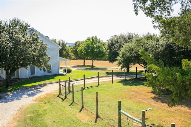 view of community with a yard and a rural view