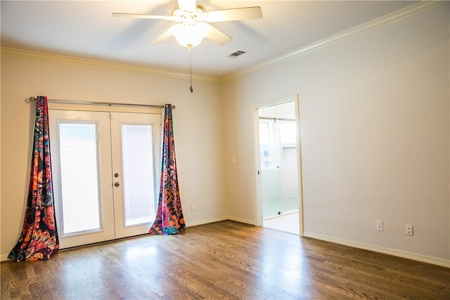 empty room featuring french doors, ceiling fan, crown molding, and dark wood-type flooring