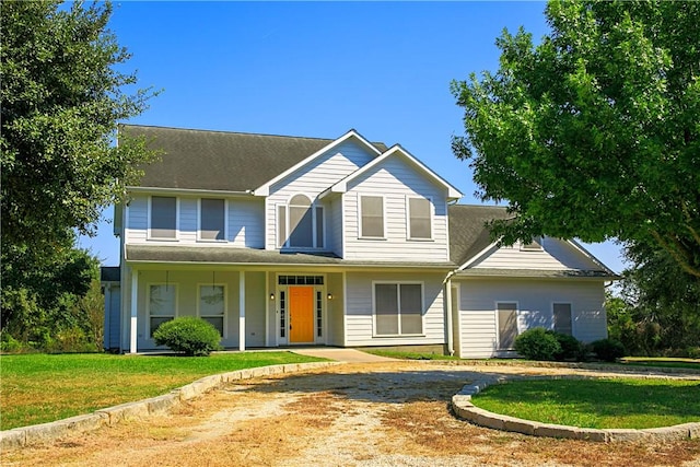 view of front of home with a front yard and covered porch