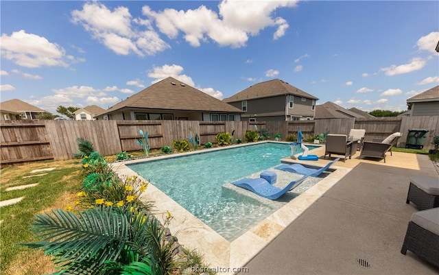 view of swimming pool featuring pool water feature and a patio