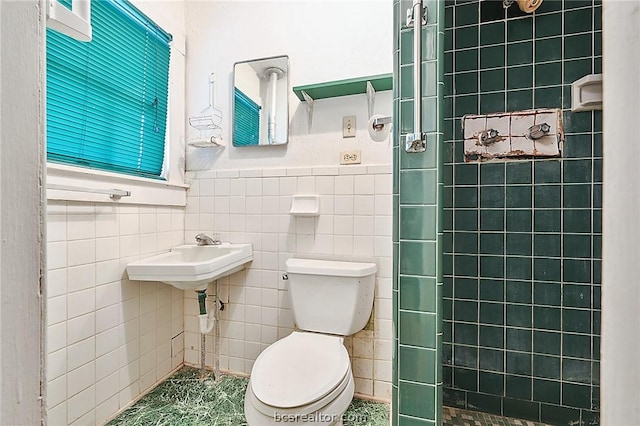 bathroom featuring toilet and tile walls