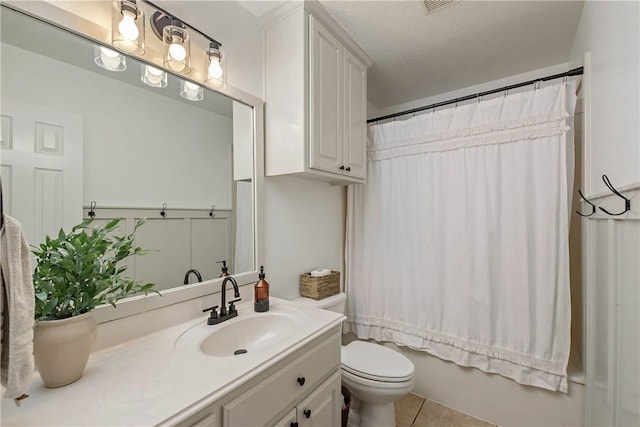 bathroom with vanity, tile patterned flooring, toilet, and shower / tub combo