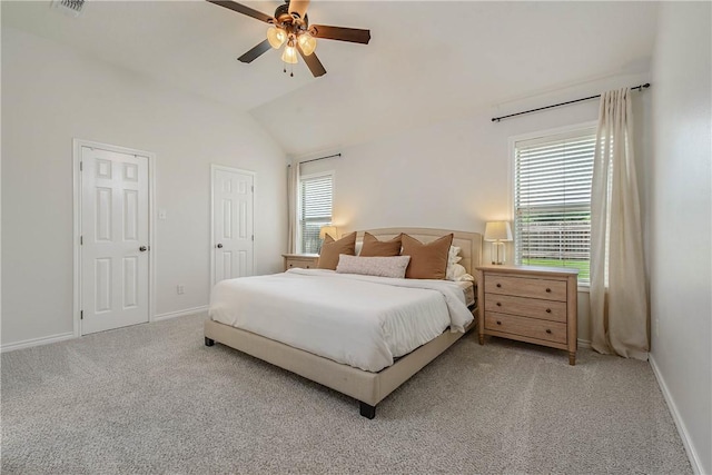 carpeted bedroom featuring baseboards, ceiling fan, lofted ceiling, and visible vents
