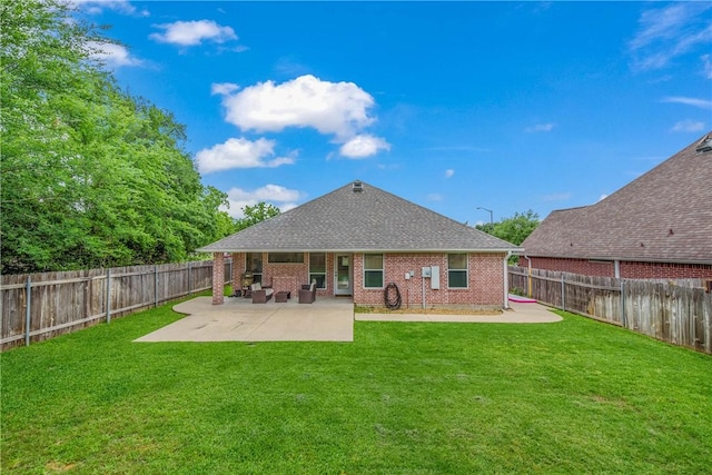 rear view of house featuring a lawn, a patio, a fenced backyard, and roof with shingles