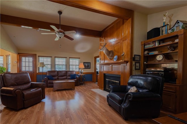 living room with vaulted ceiling with beams, ceiling fan, and light hardwood / wood-style floors